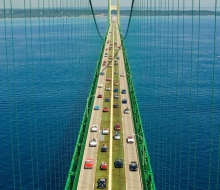 Convertibles carrying honored guests across the Makcianc Bridge during the 50th anniversary Celebration