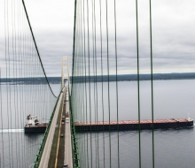 Mackinac Bridge, Looking south, shot from the North Tower, with Fog, and freighter going under bridge.